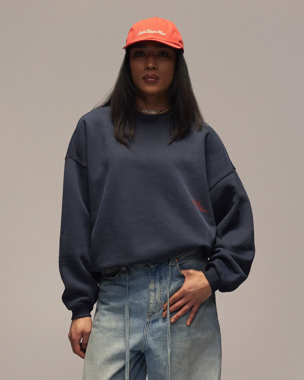 Sixth Bloom House Logo Crewneck Navy – front view, worn by woman