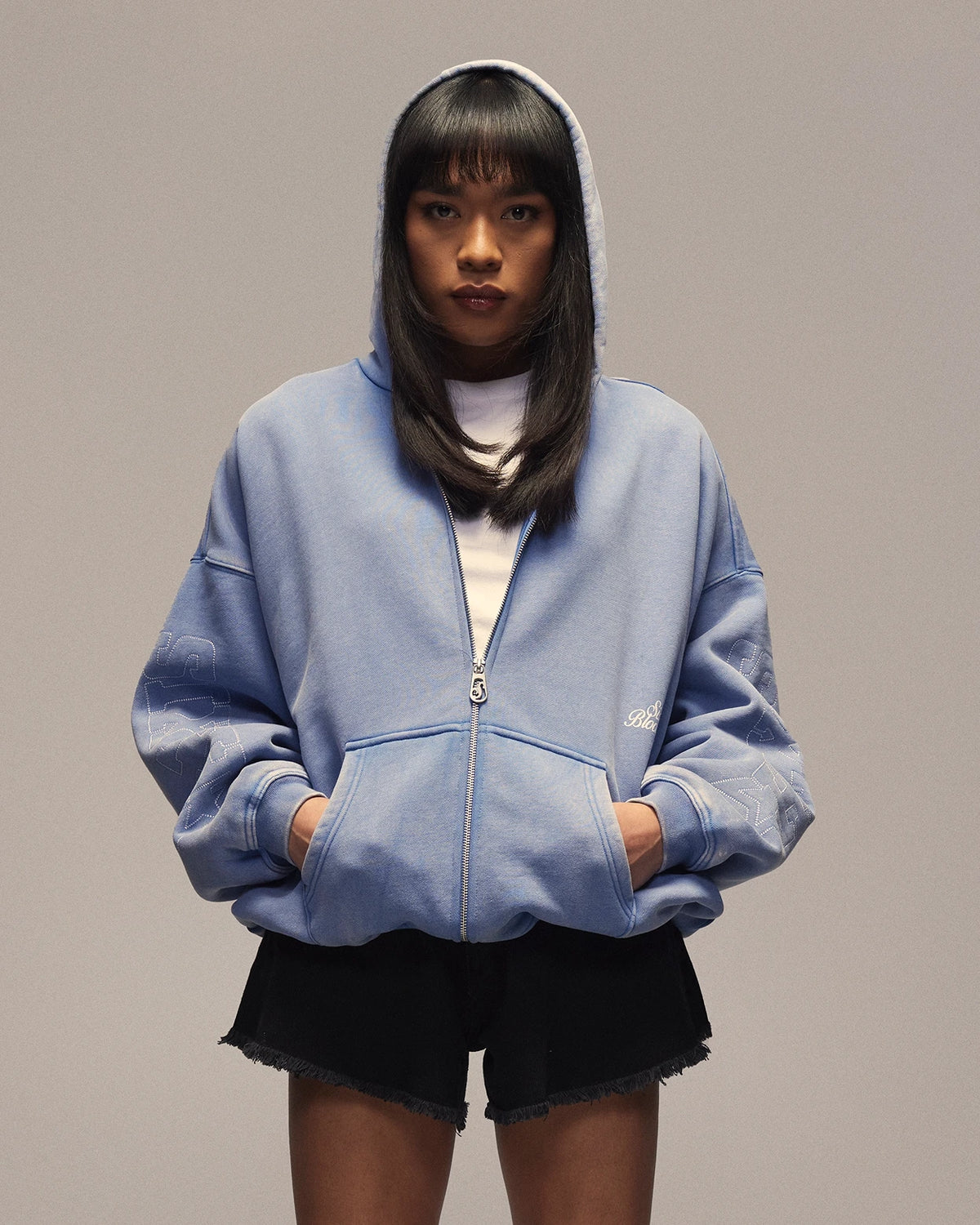 Sixth Bloom House Sixth Zip Through Hoodie Blue – front view, worn by woman