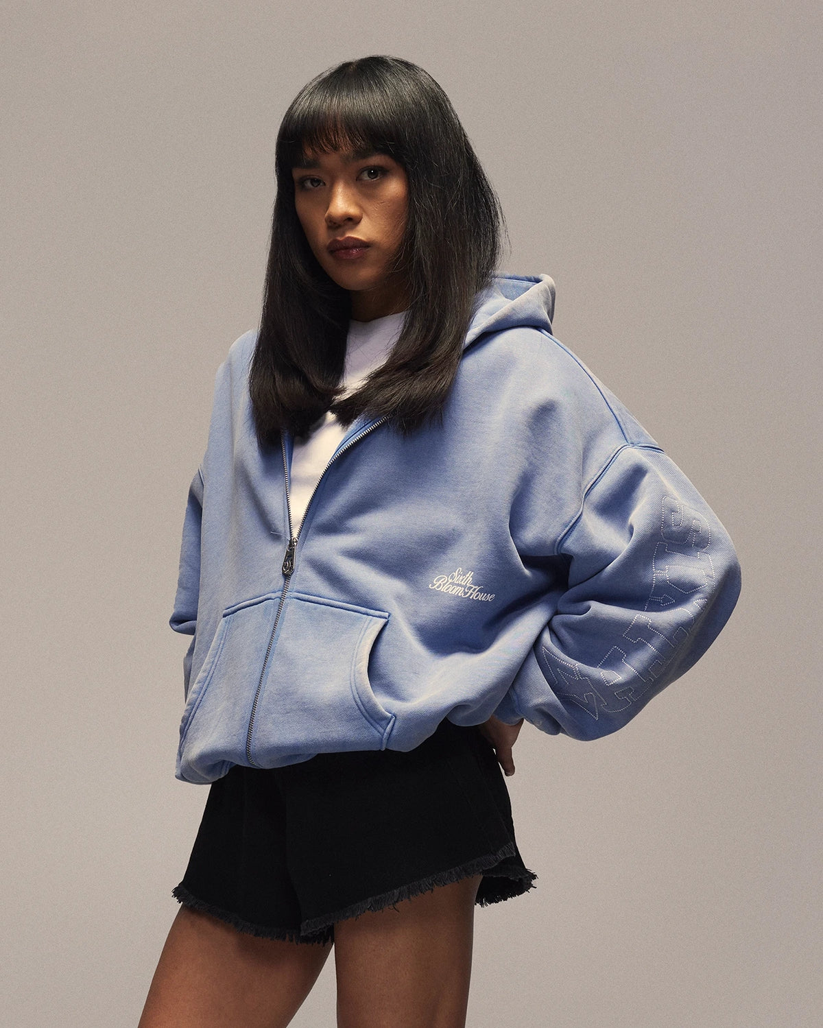 Sixth Bloom House Sixth Zip Through Hoodie Blue – side view, worn by woman