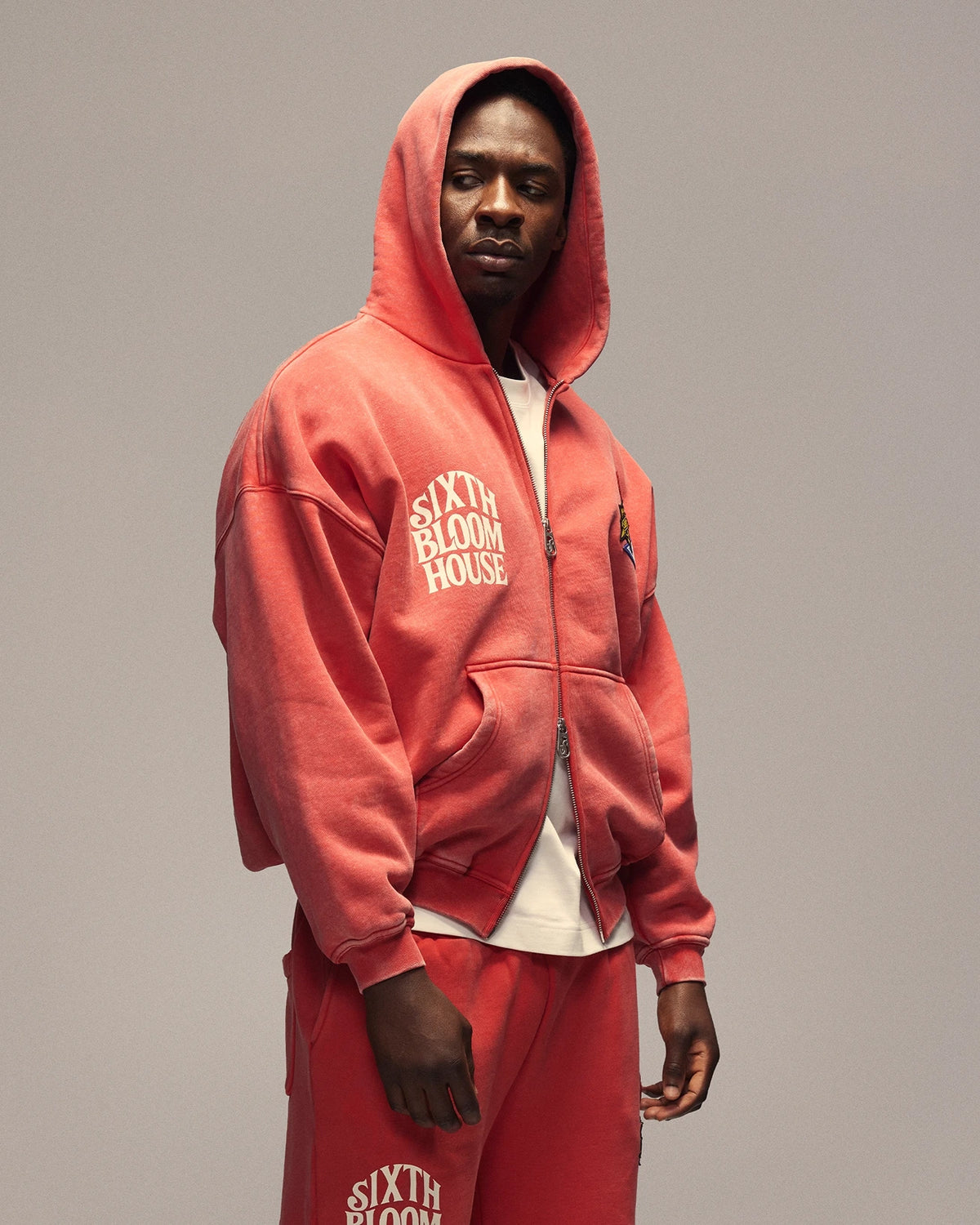 Sixth Bloom House Sixth Zip Through Hoodie Red – side view with hood up, showing the arched chest print
